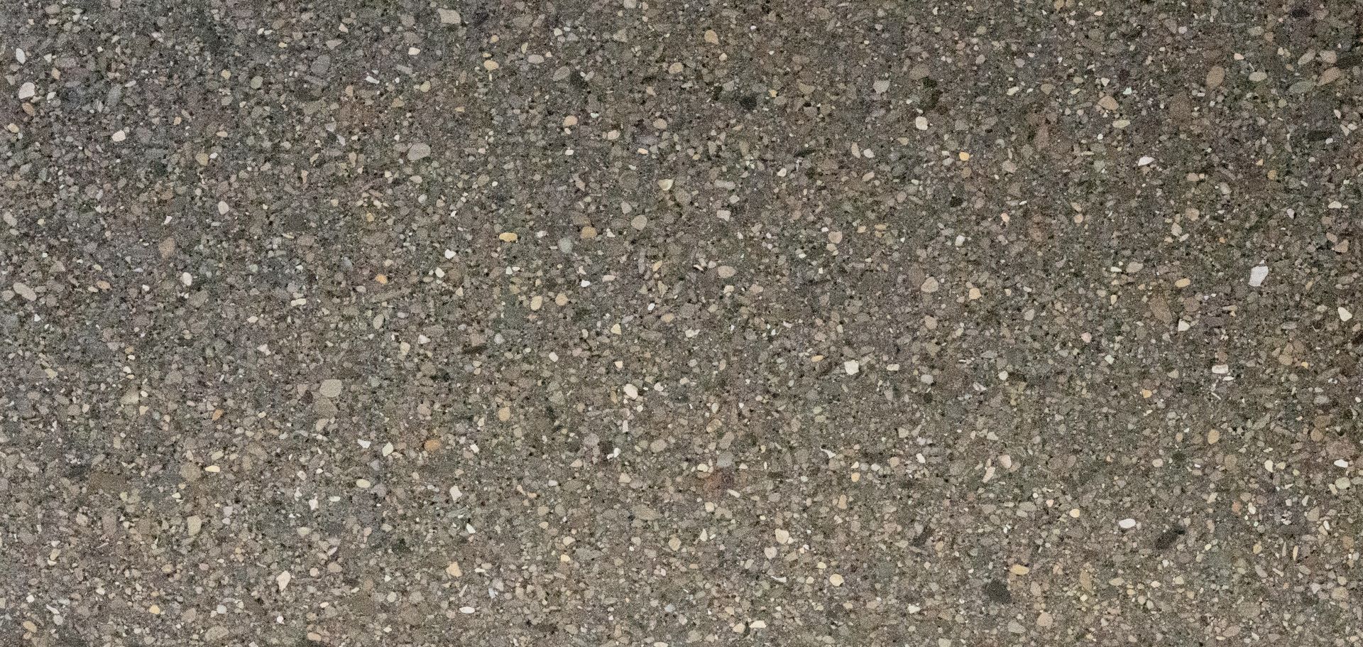 Close-up of coarse gray-brown gravel or asphalt texture