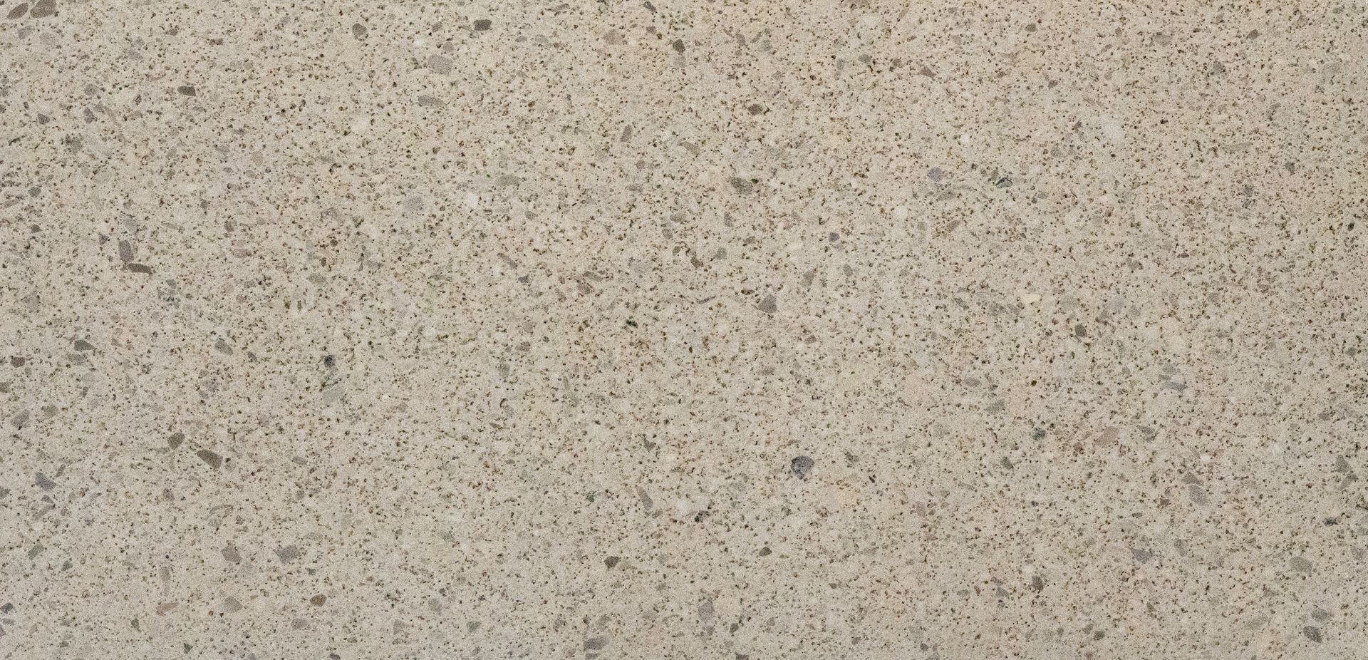 Speckled beige textured surface with small dark flecks