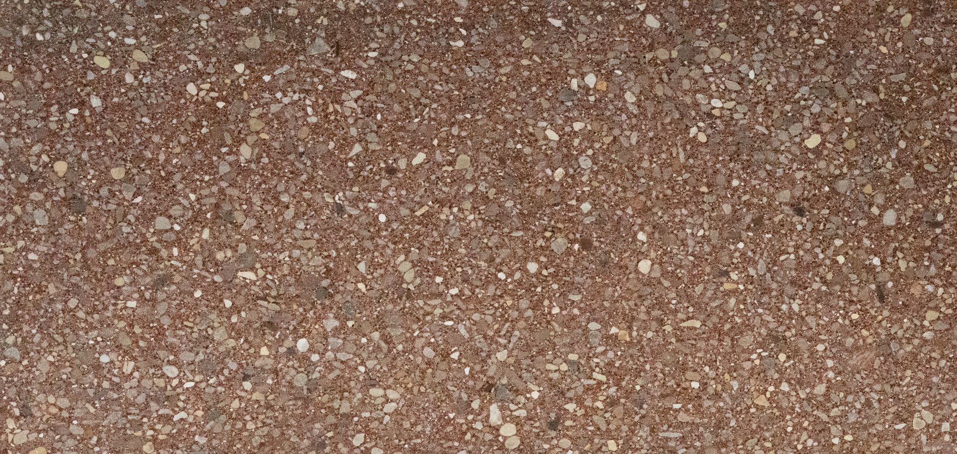 Close-up of a brown, speckled gravel or pebbled surface