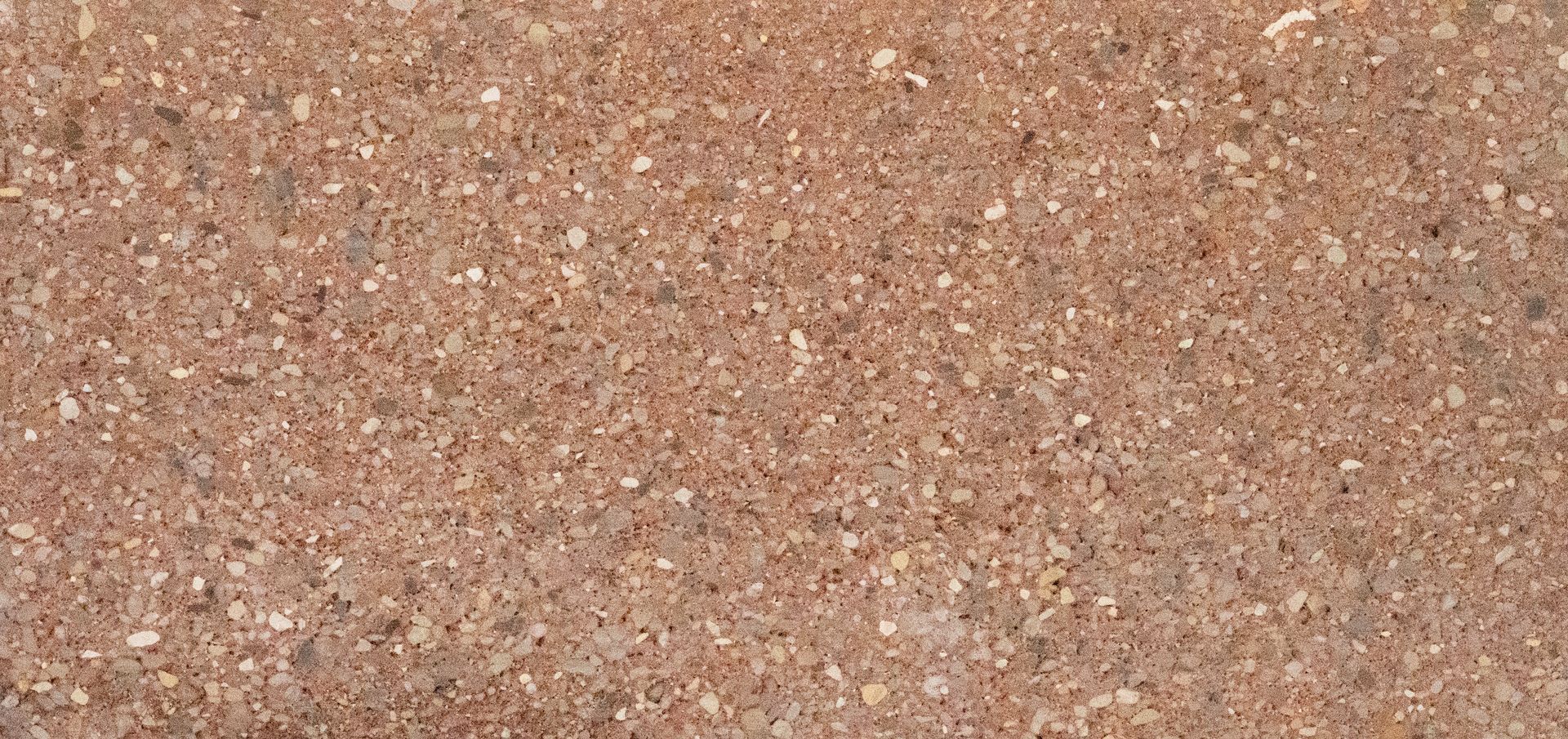 Close-up of a pinkish-brown speckled stone or gravel surface