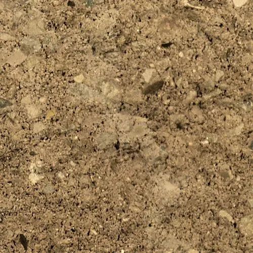 Close-up of brown dirt and small rocks mixed together, appearing dry and textured.