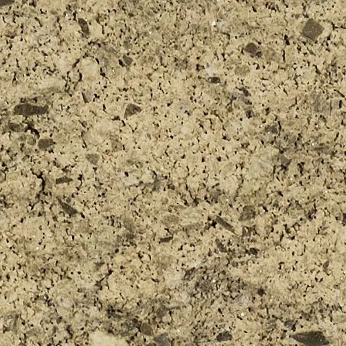 Close-up of a rough, tan-colored stone surface with visible flecks and variations in texture.