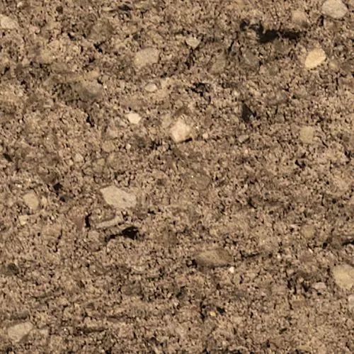 Close-up of rough, brown aggregate material with small, light-colored stones.