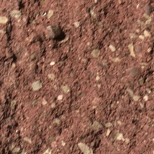 Red soil with small rocks and pebbles.