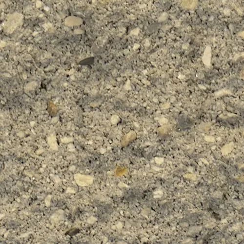 Close-up of gray concrete with various small stones and pebbles embedded.