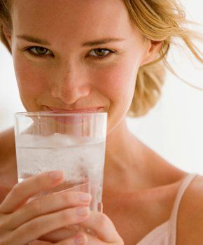 Woman drinking clean water from glass