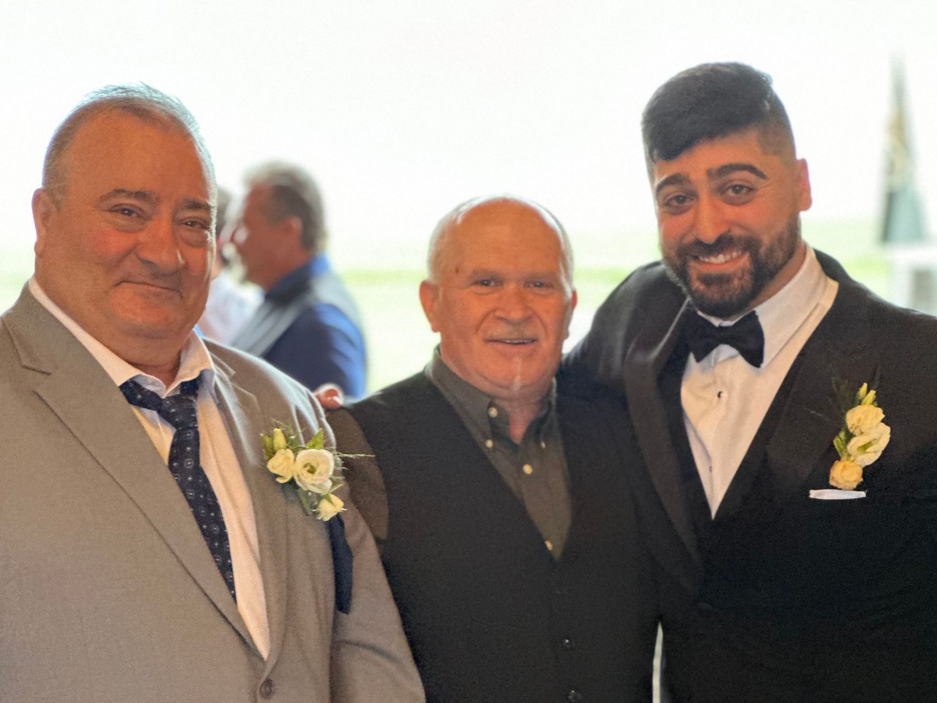 A man in a pizza costume is standing in front of a brick building.