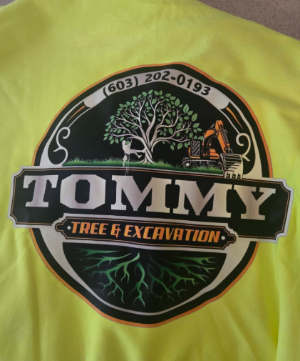 Bright yellow shirt with a circular Tommy Tree & Excavation logo and tree-cutting graphic