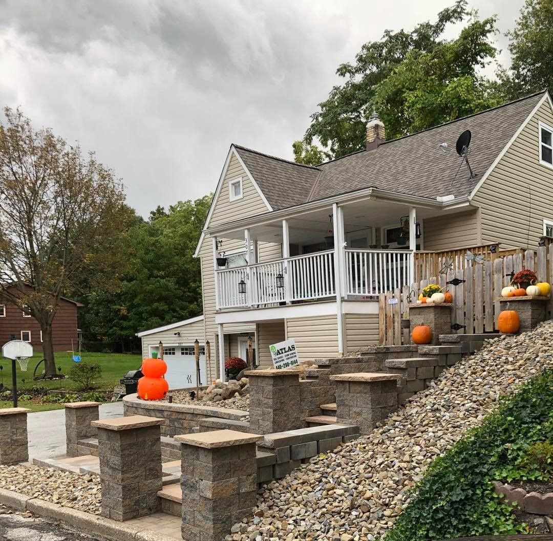 A house decorated for halloween with pumpkins on the porch