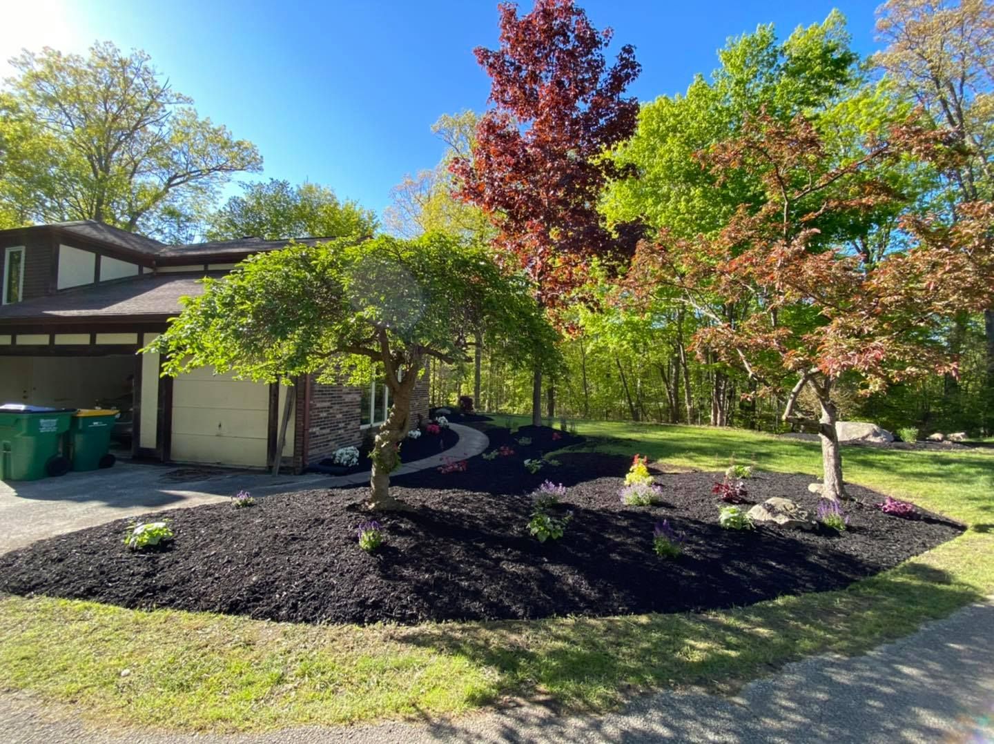 A house with a lot of mulch in front of it
