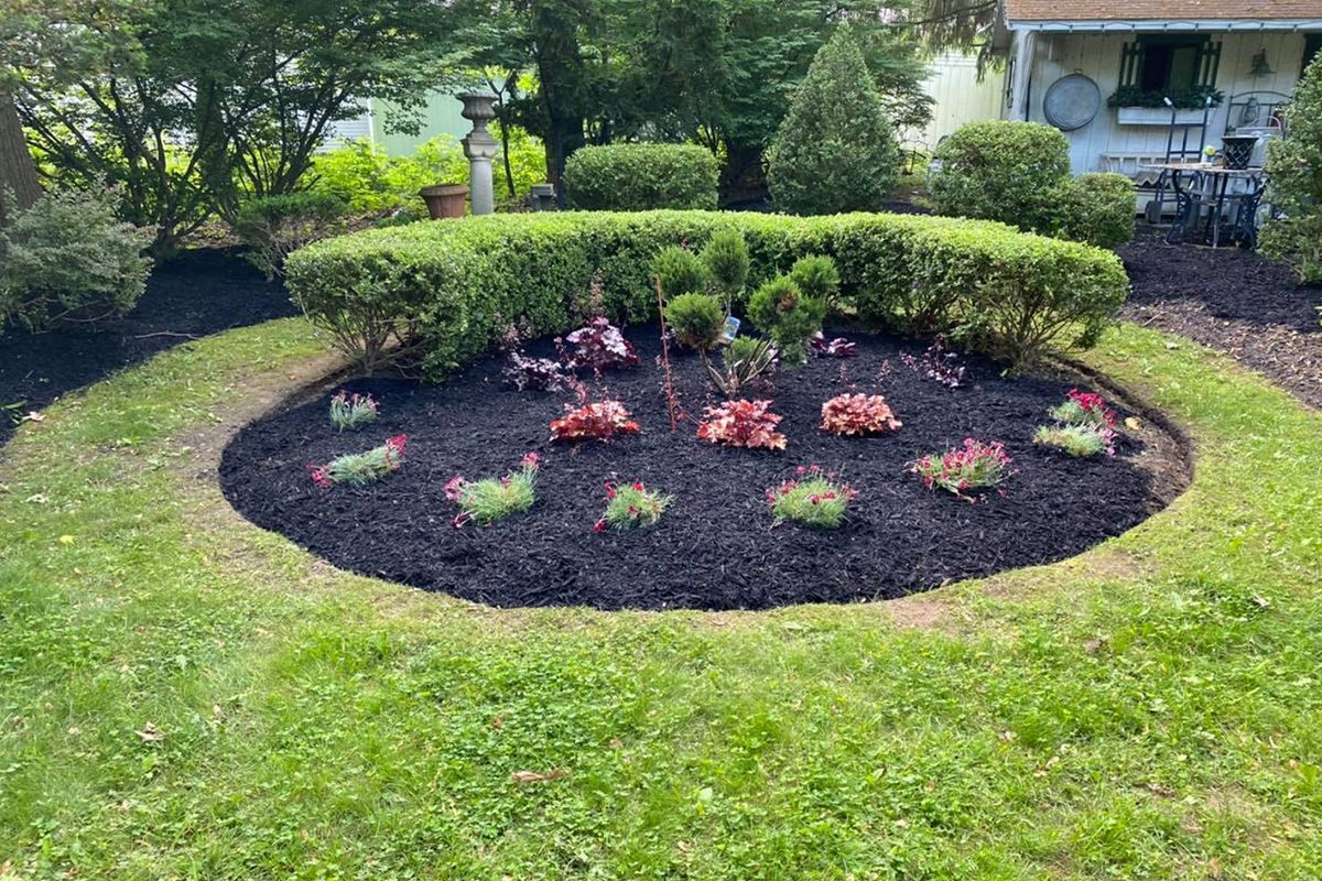 There is a circular garden in the middle of the yard.