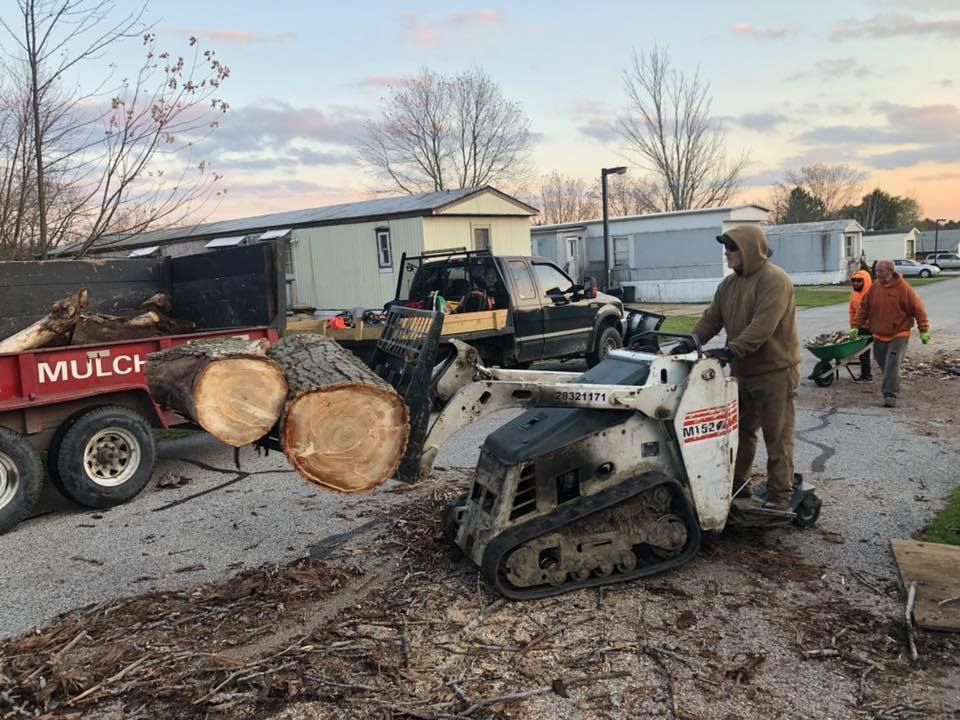 A brick building with a walkway leading to it and a garden in front of it.