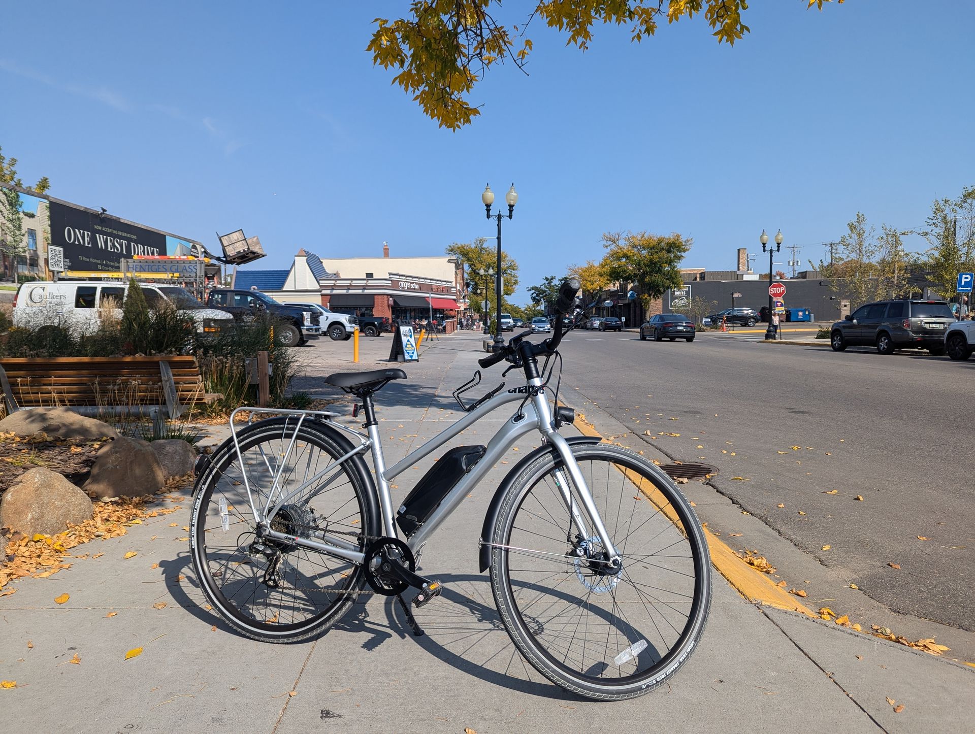 A bicycle is parked on the sidewalk on a sunny day