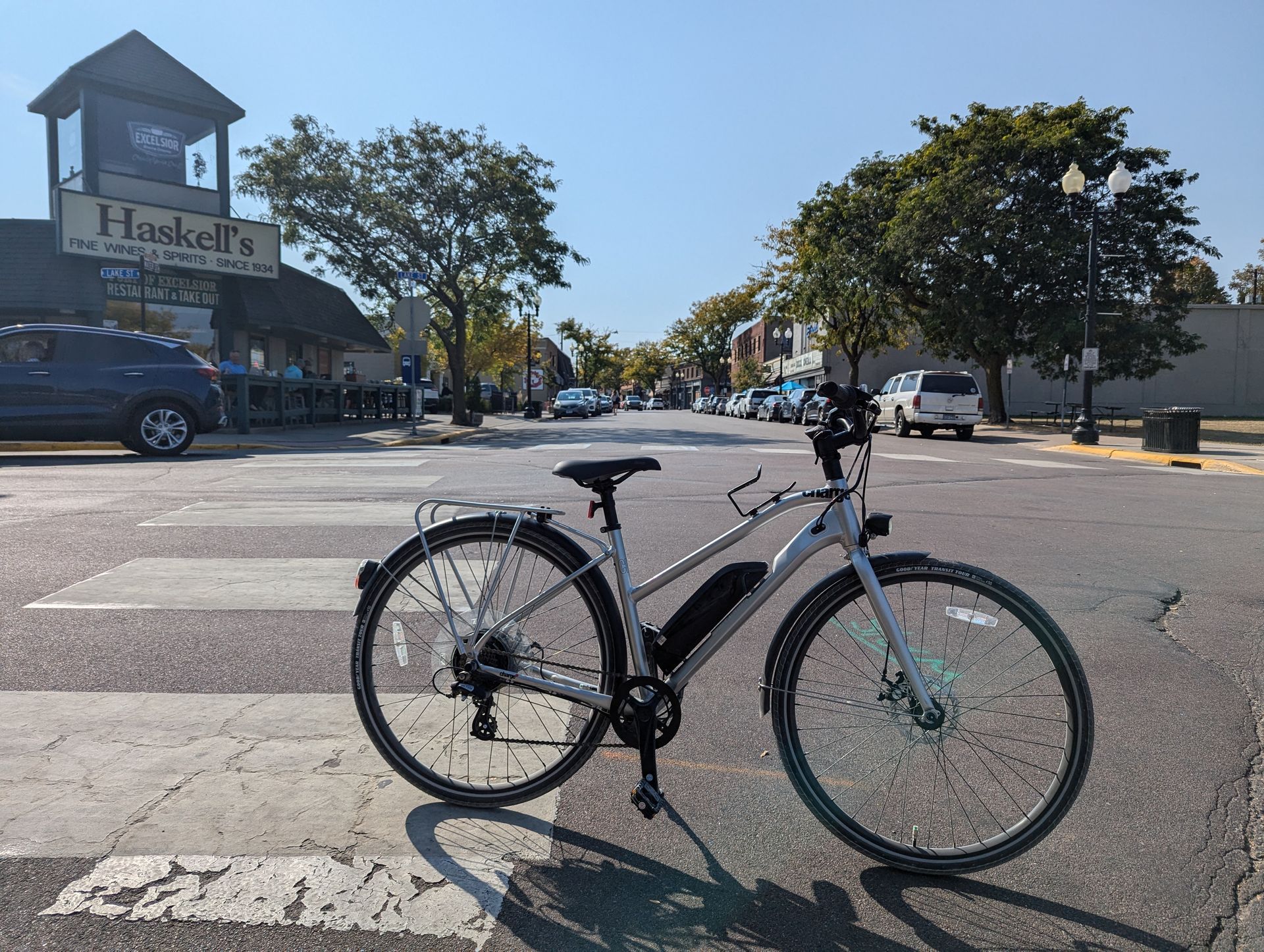 A bicycle is parked on the side of the road in front of hawker 's