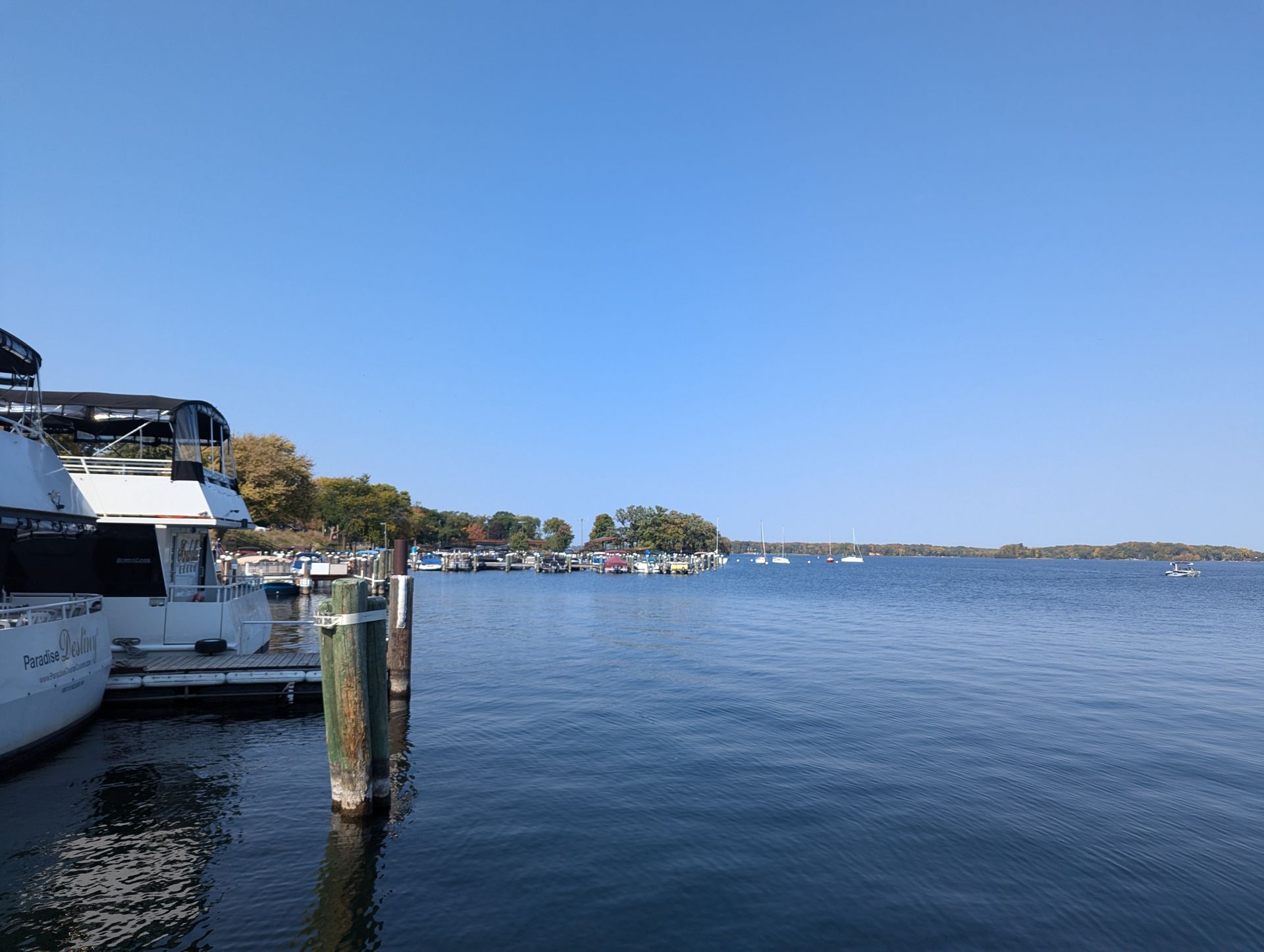 A large body of water with boats docked at a dock.