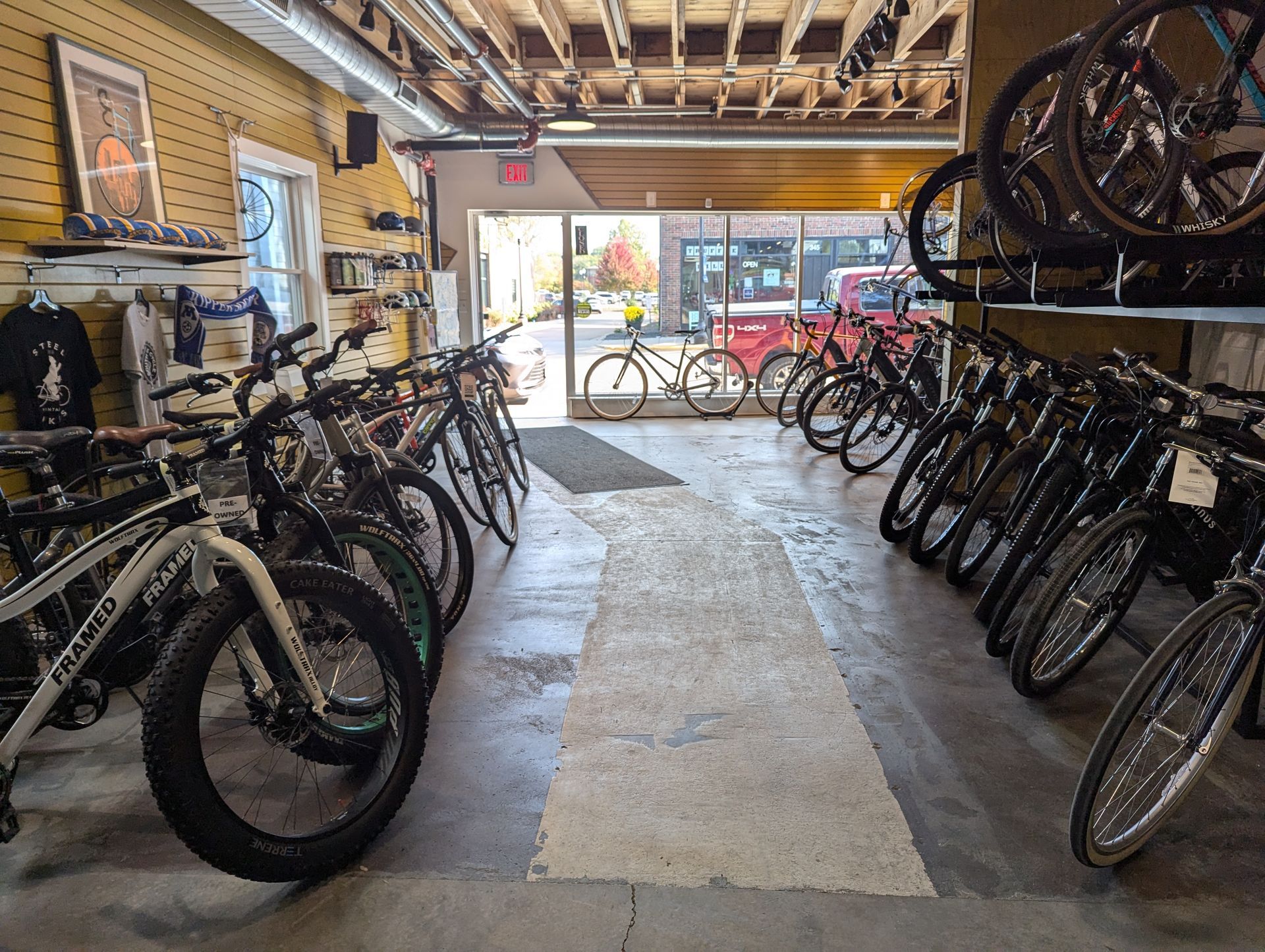 A row of bicycles are lined up in a store.