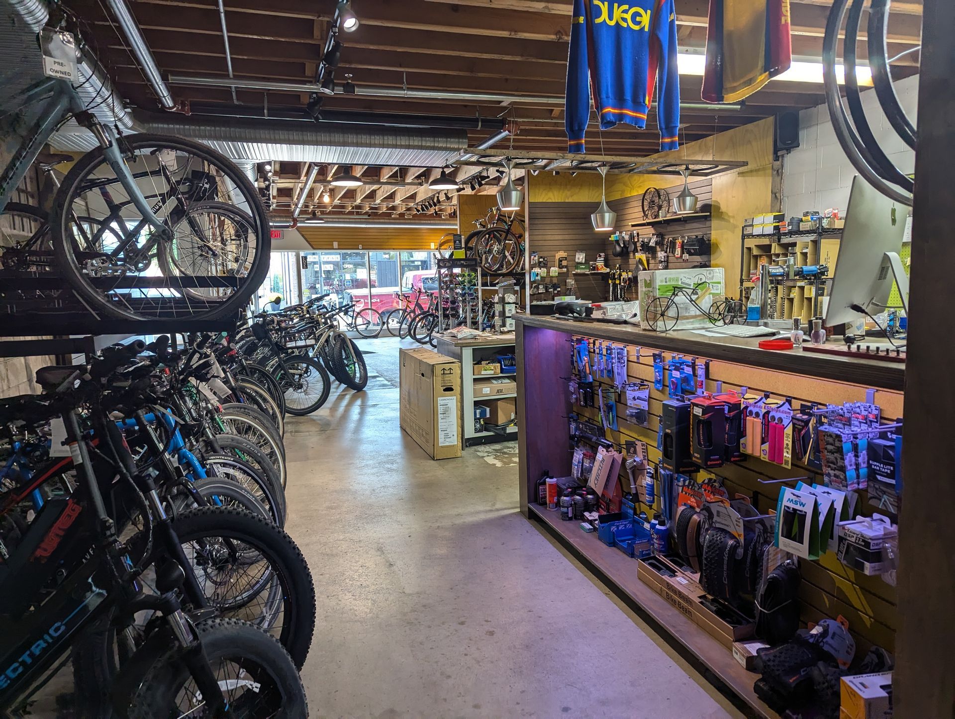 A row of bicycles are lined up in a bicycle shop.