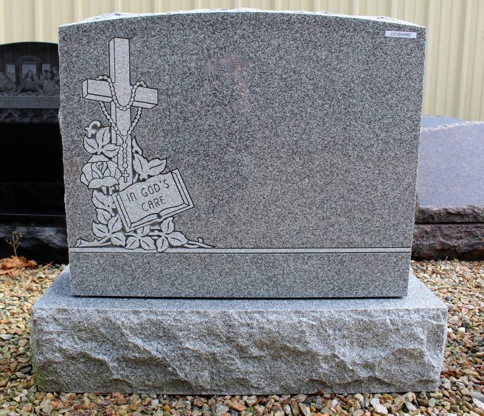 A gravestone with a cross and a book on it.