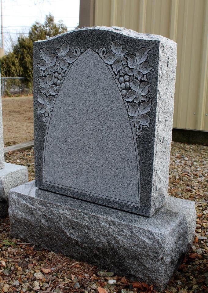 A gravestone with a floral design on it