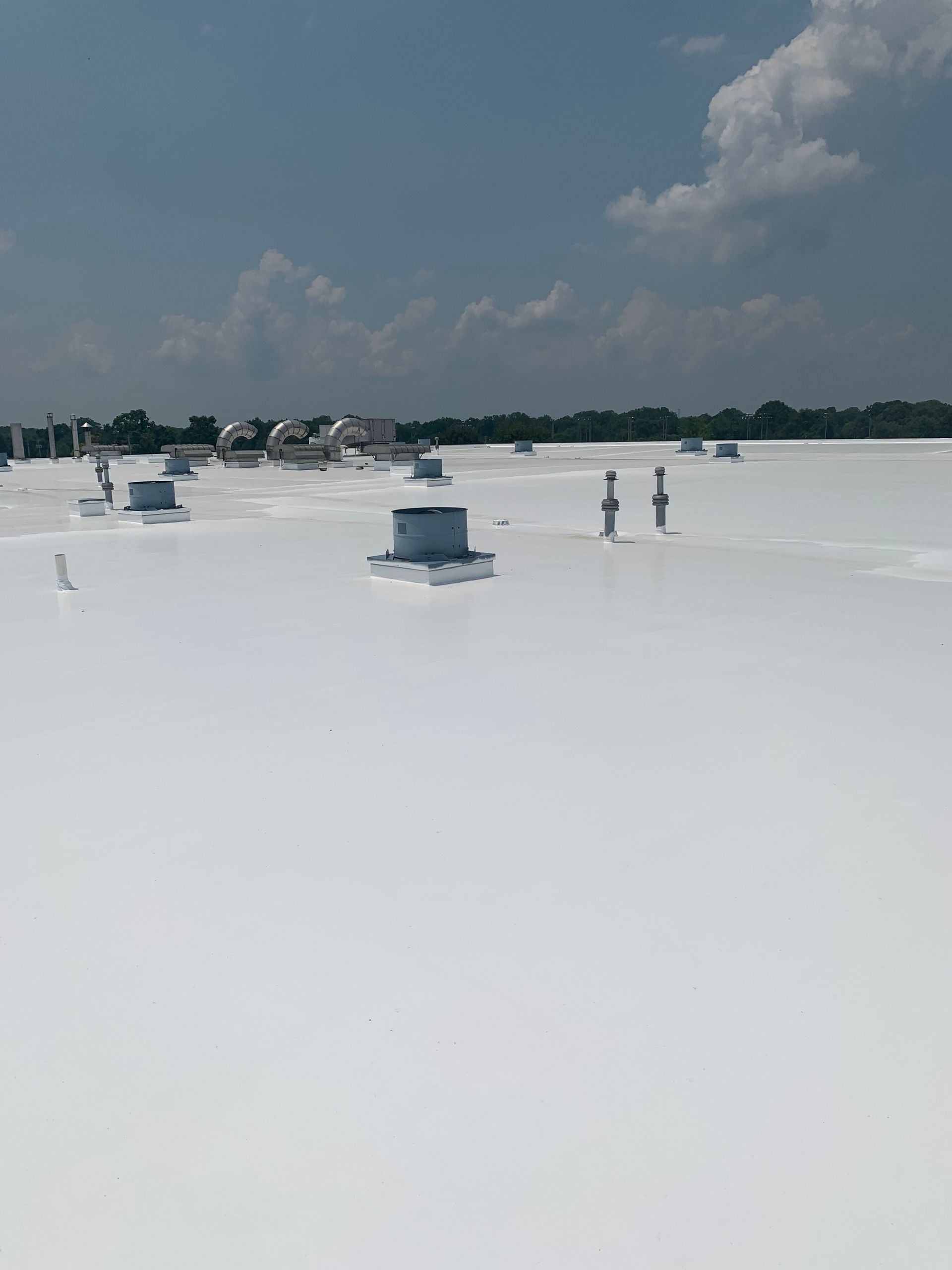 A large white roof with a lot of vents on it.