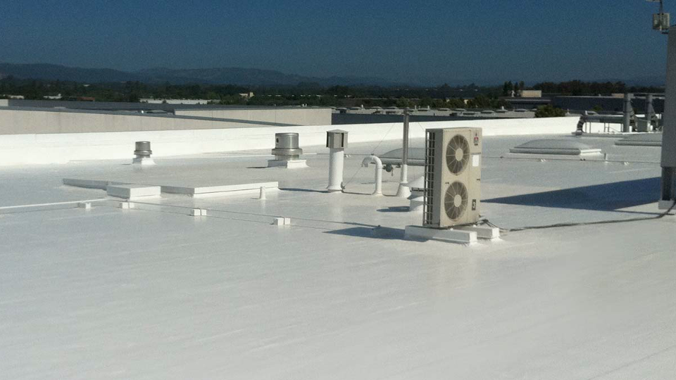 A white roof with two air conditioners on it