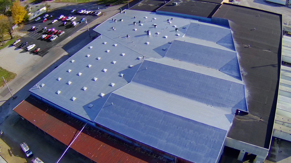 An aerial view of a large building with a roof that looks like an american flag.