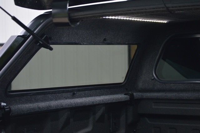 Interior of a black car with an open side window