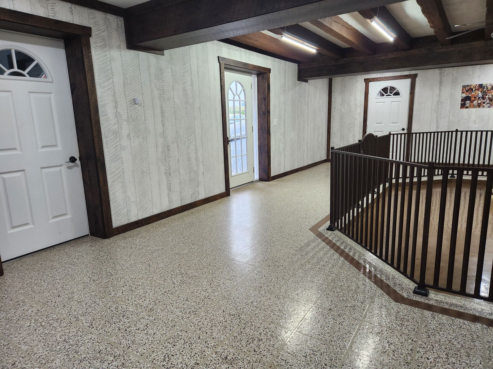 A hallway with a staircase leading up to the second floor of a house.