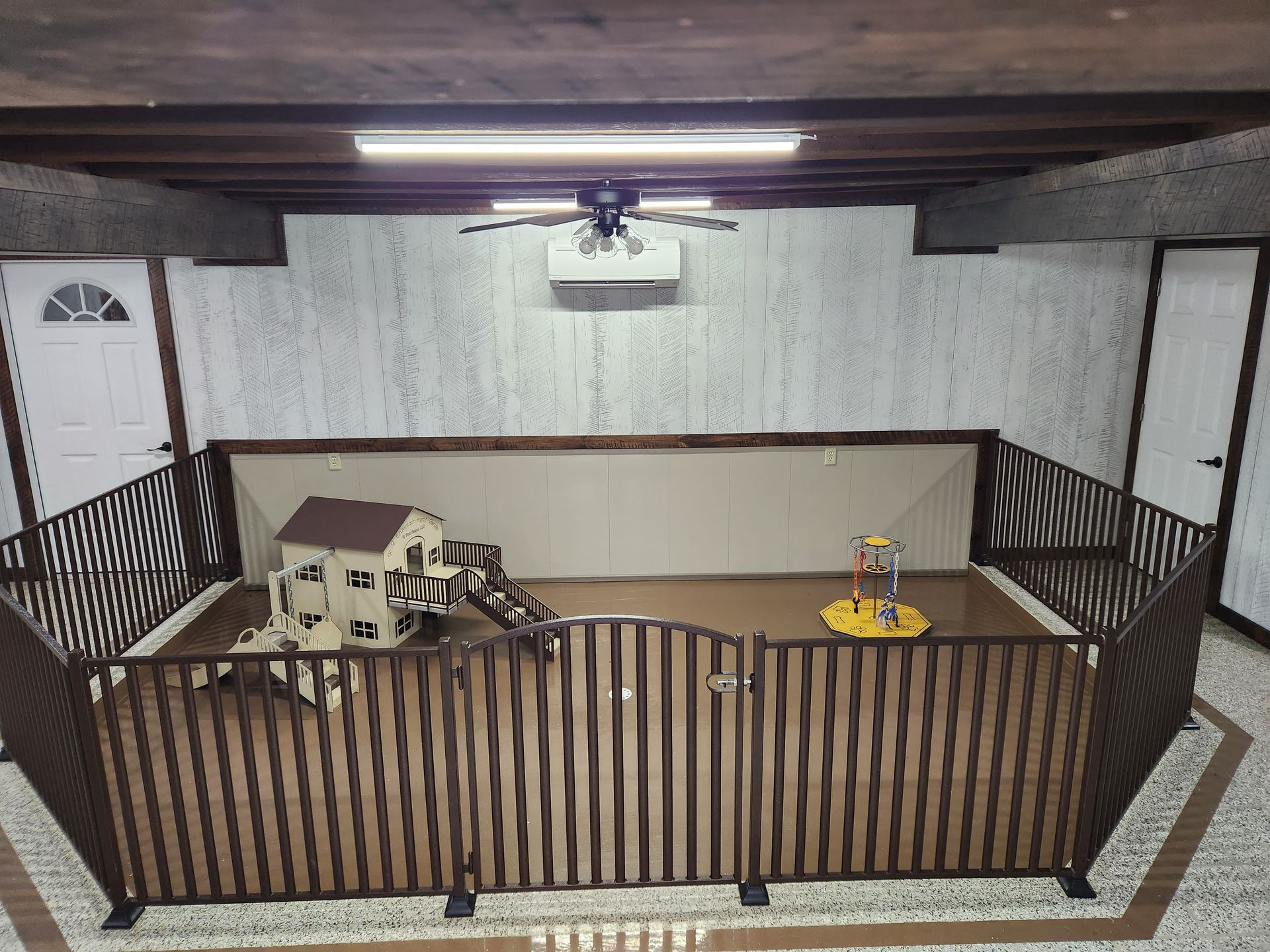 A room with a fence and a house in it