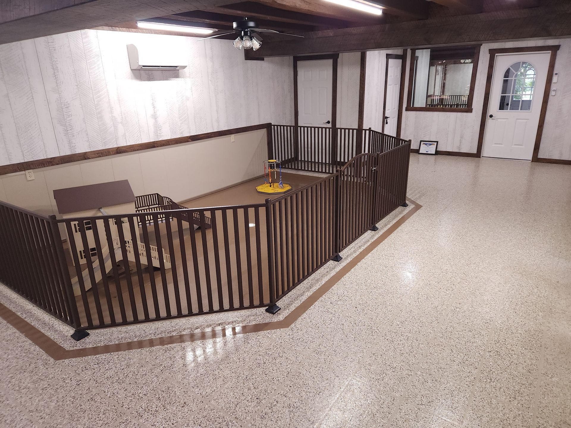 A room with a fence and a couch in it