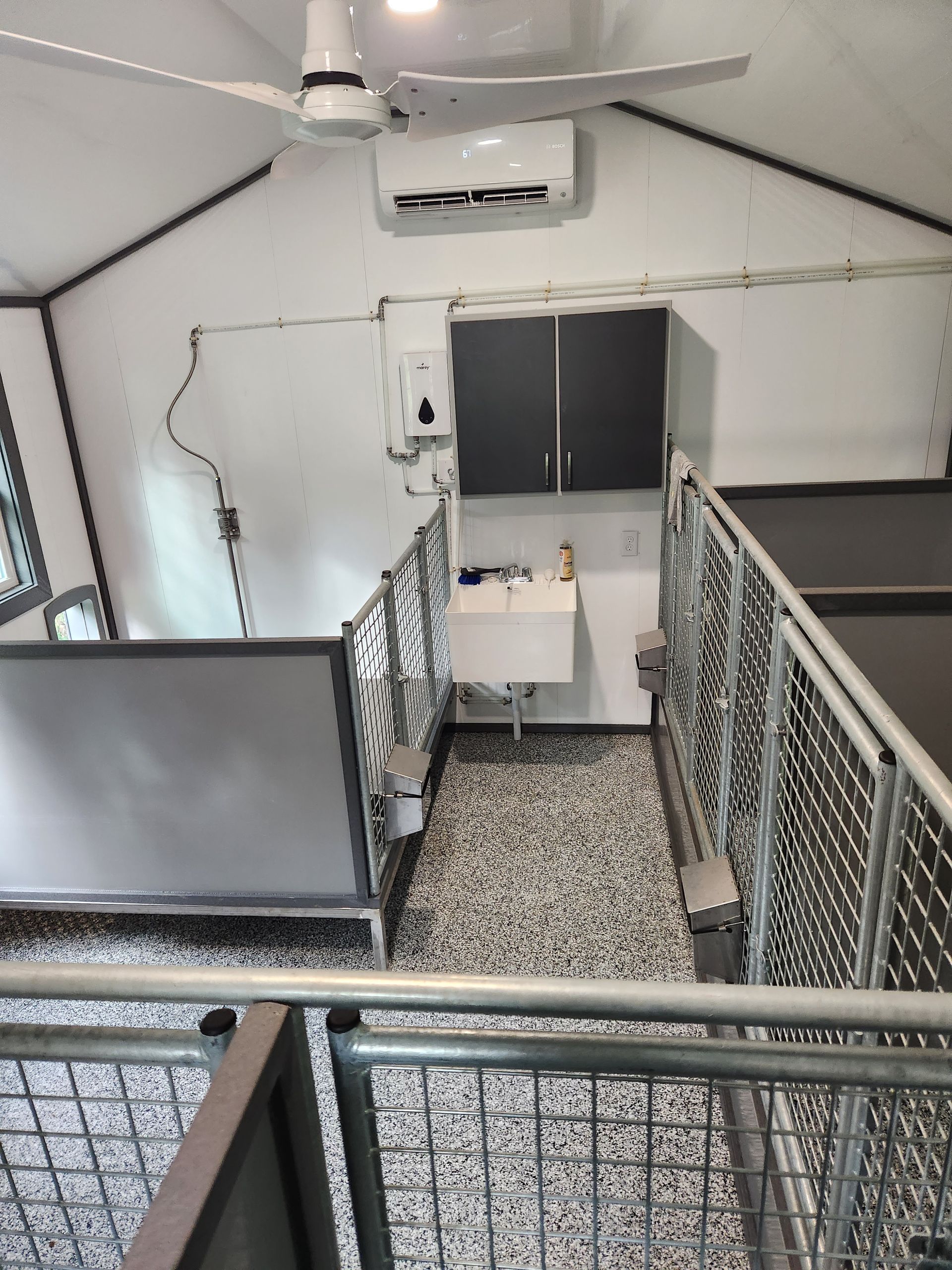 A room with a sink and a ceiling fan