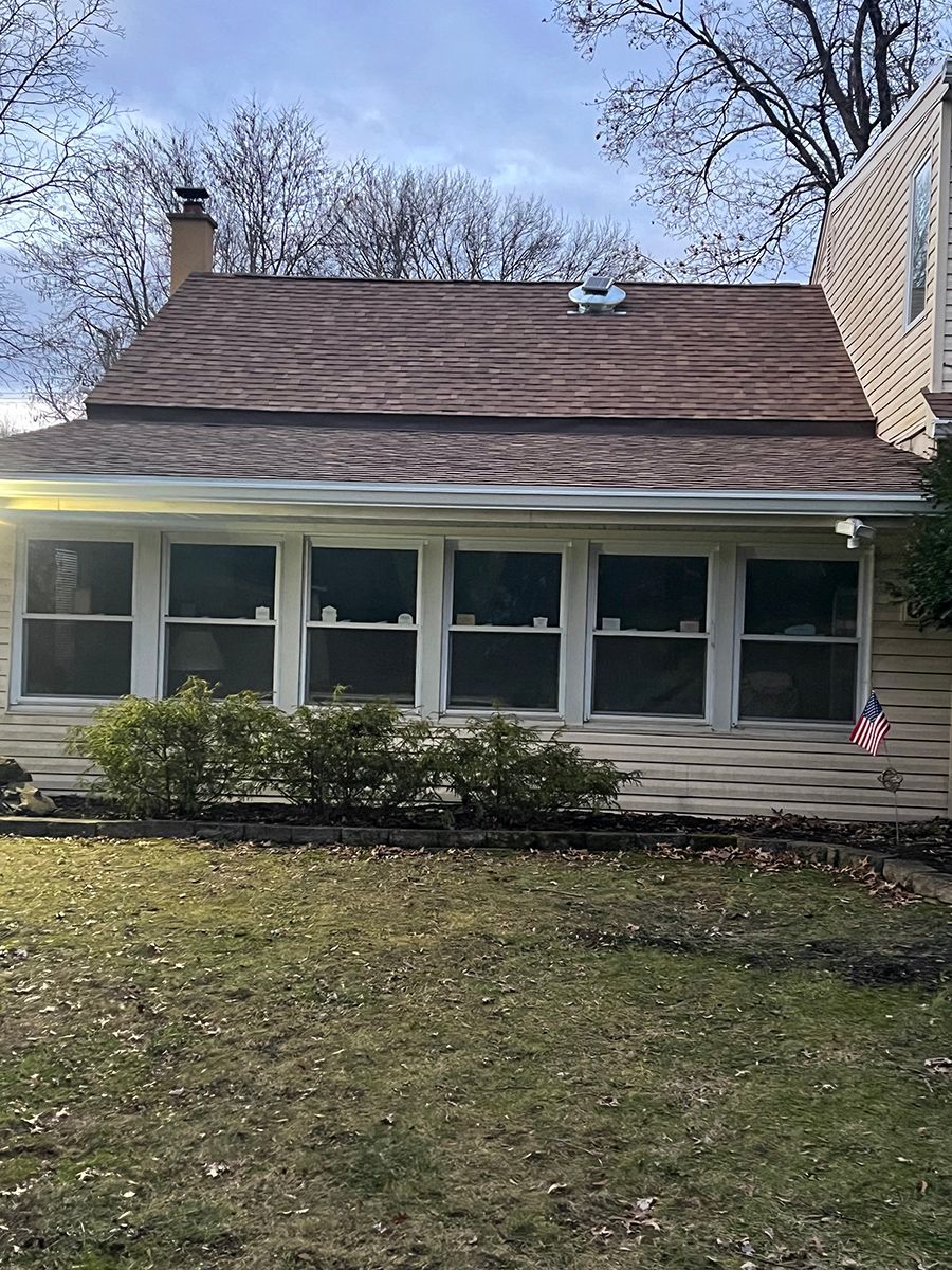 A house with a brown roof and a lot of windows.