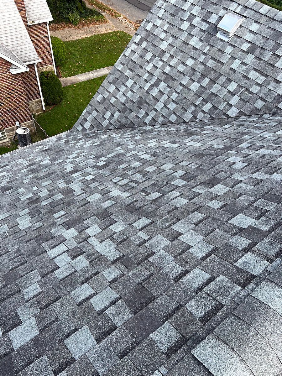 A close up of a roof with a lot of shingles on it.