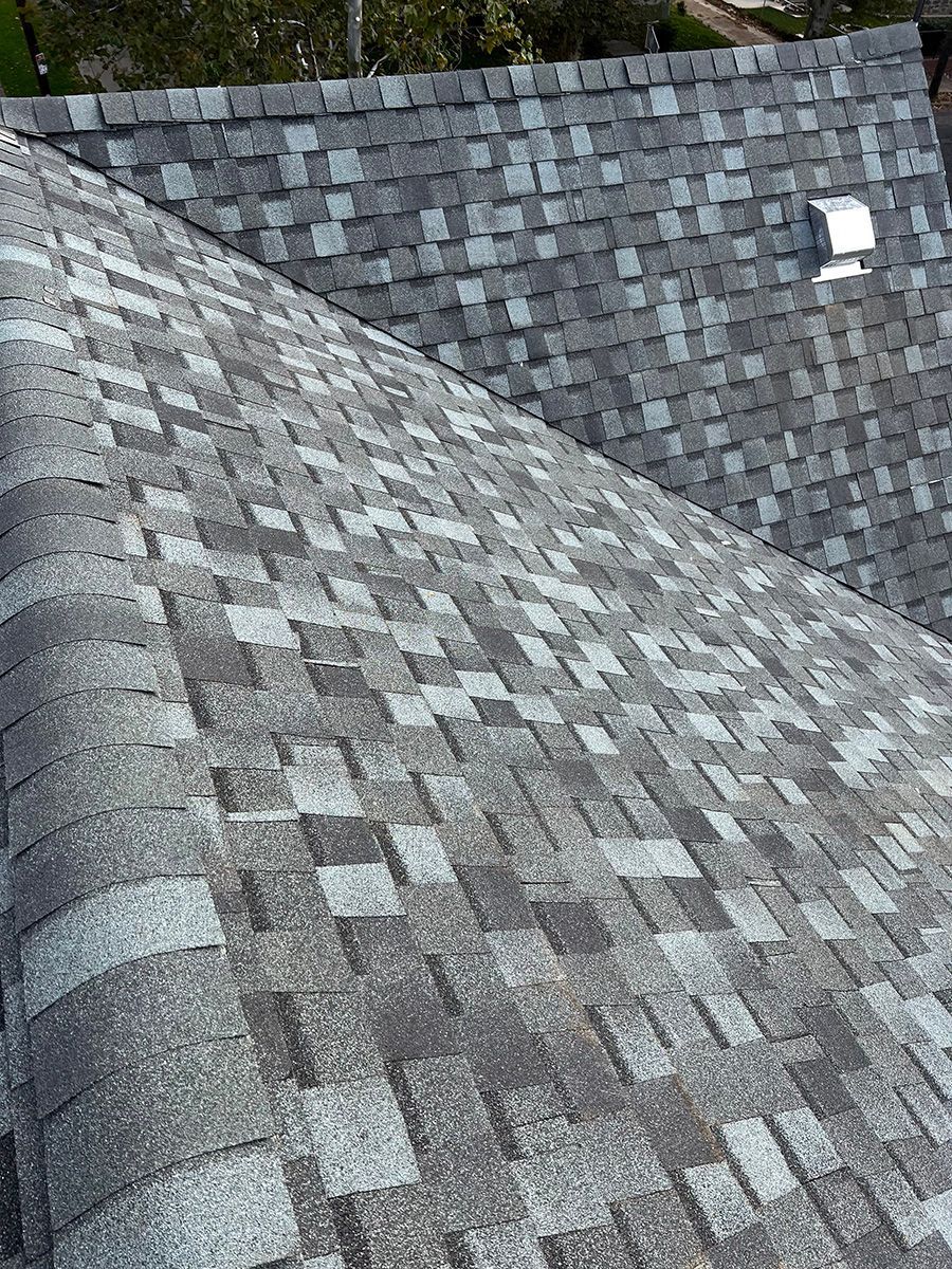 A close up of a roof with a lot of shingles on it.