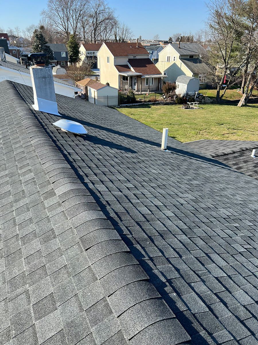 The roof of a house with a chimney on it.