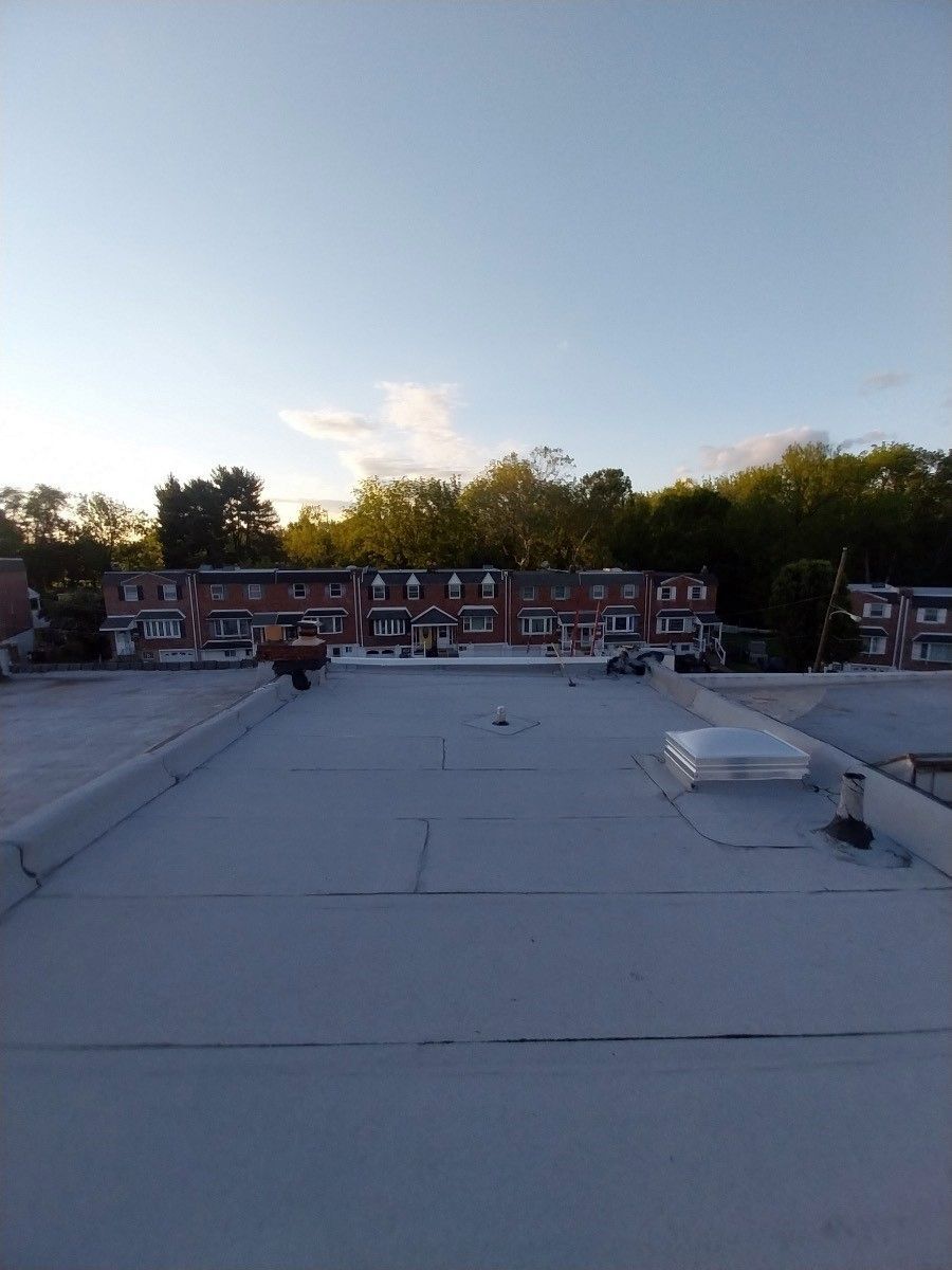 A rooftop with a lot of buildings in the background