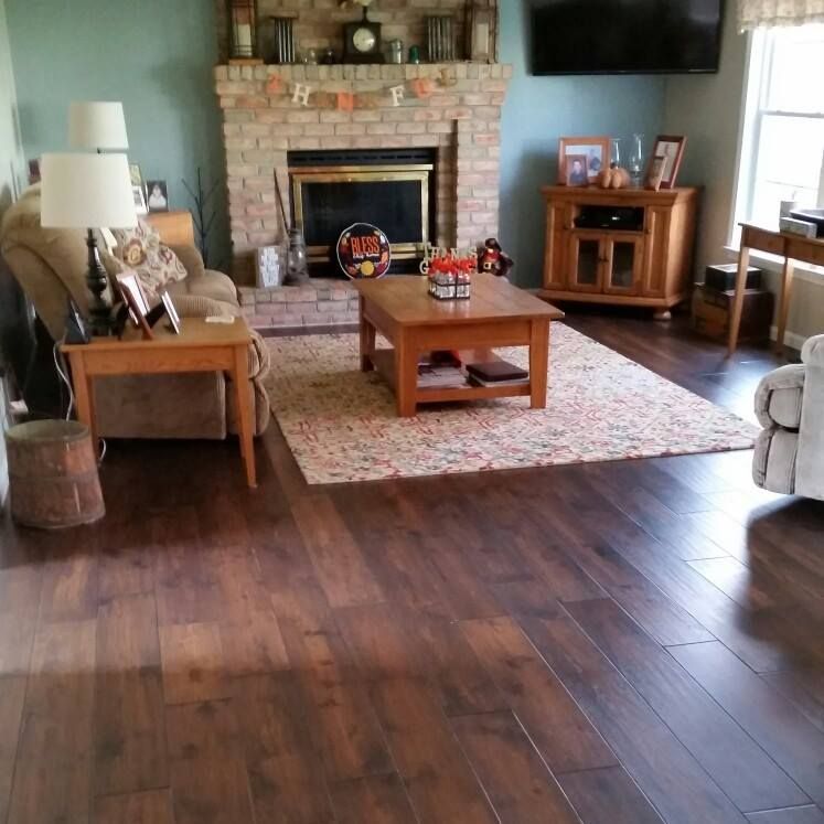 A living room with hardwood floors and a fireplace