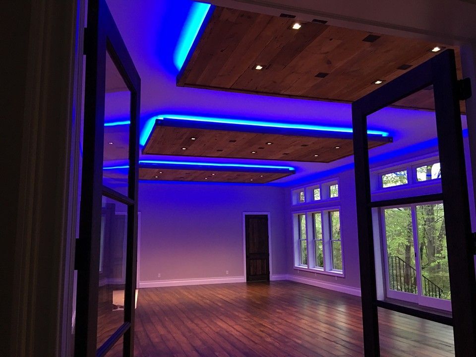 A large empty room with blue lights on the ceiling.