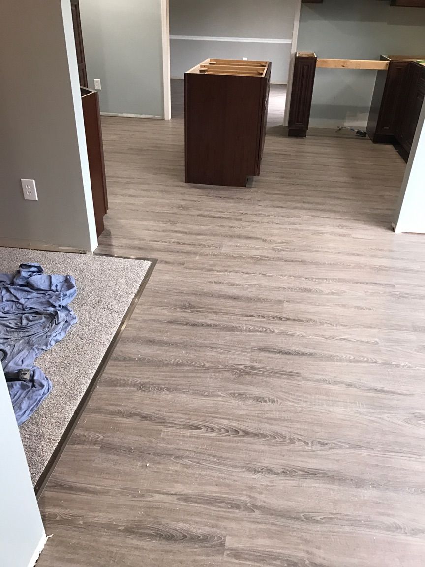 A room with a wooden floor and a carpeted floor.