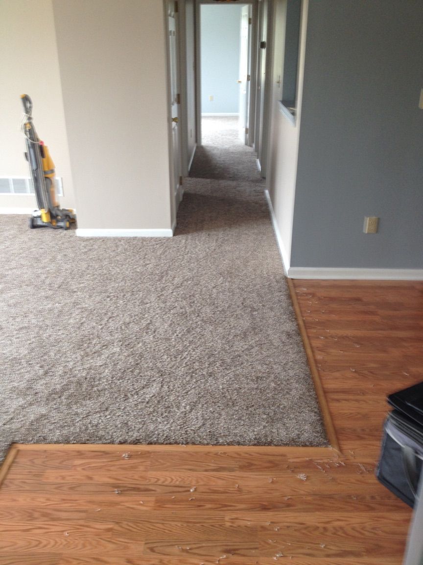 A vacuum cleaner is sitting on the floor in a hallway.