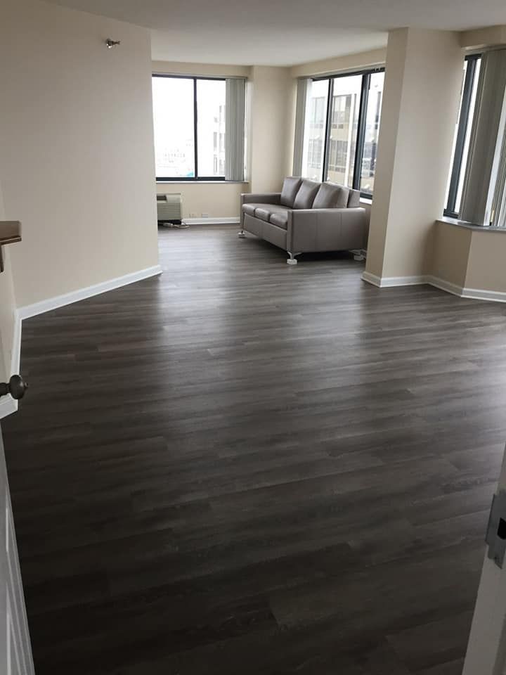 A living room with hardwood floors and a couch.