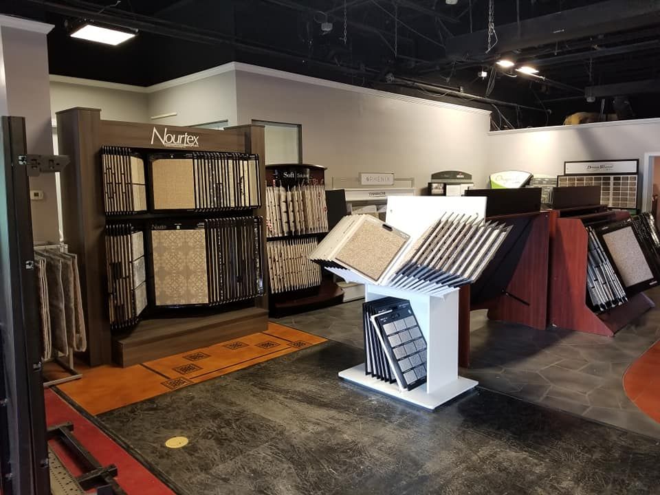 A showroom filled with lots of carpets and tiles.