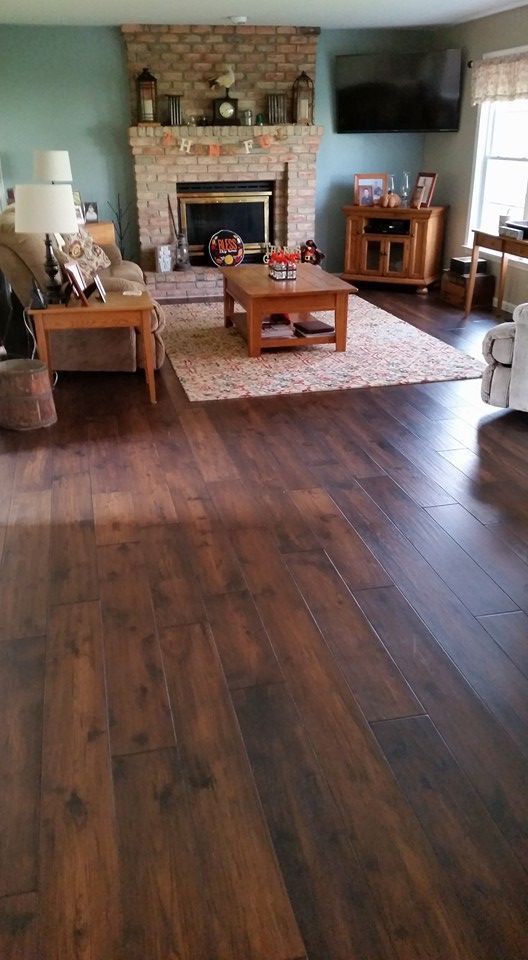 A living room with hardwood floors and a fireplace.