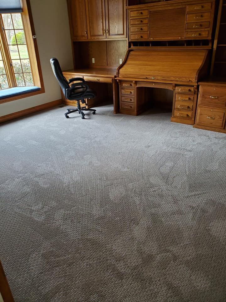 There is a desk and a chair in the room.