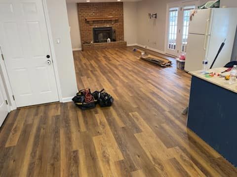 A living room with hardwood floors and a fireplace.