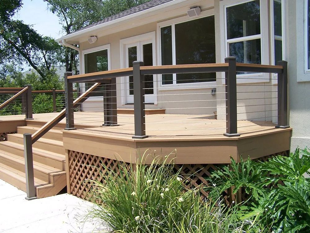 a house with a deck and stairs in front of it