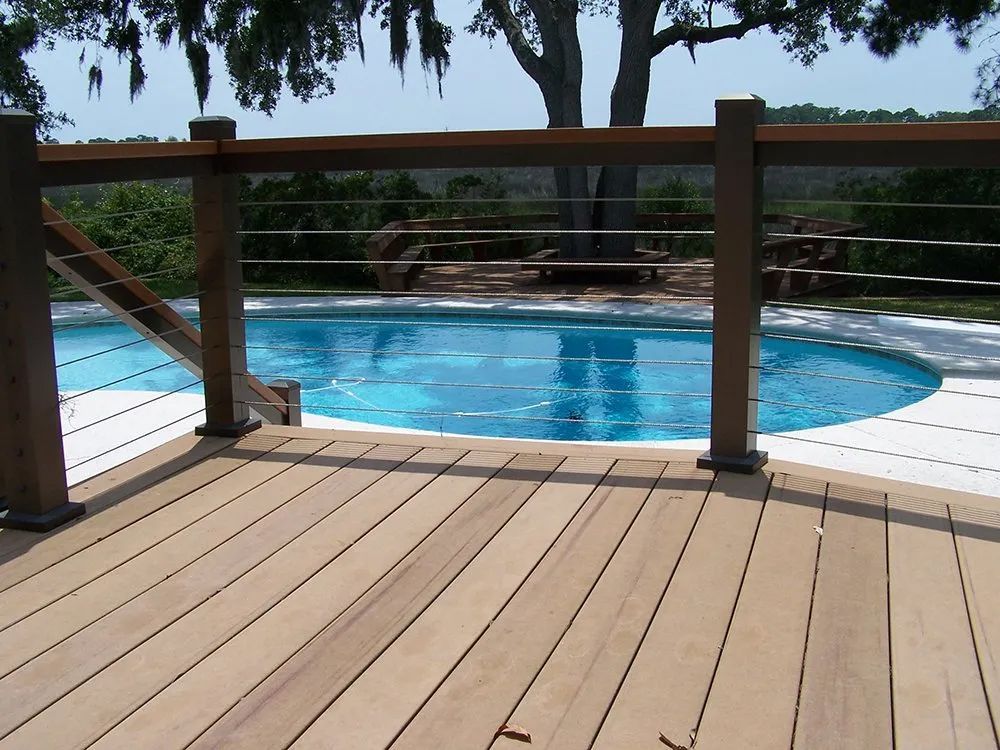 a wooden deck overlooking a large swimming pool