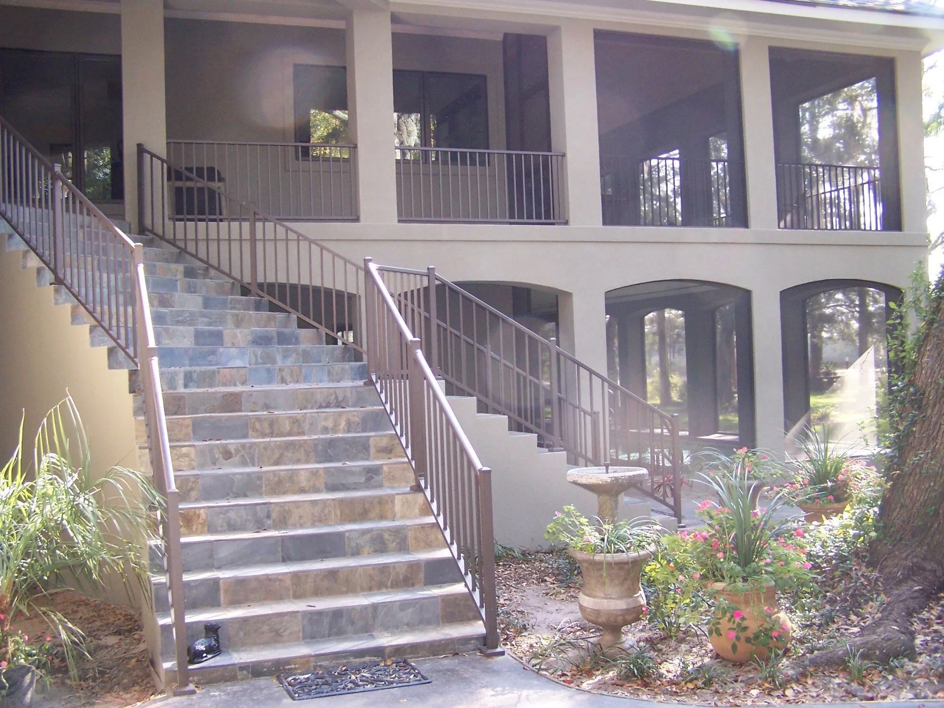 a house with stairs leading up to a screened in porch