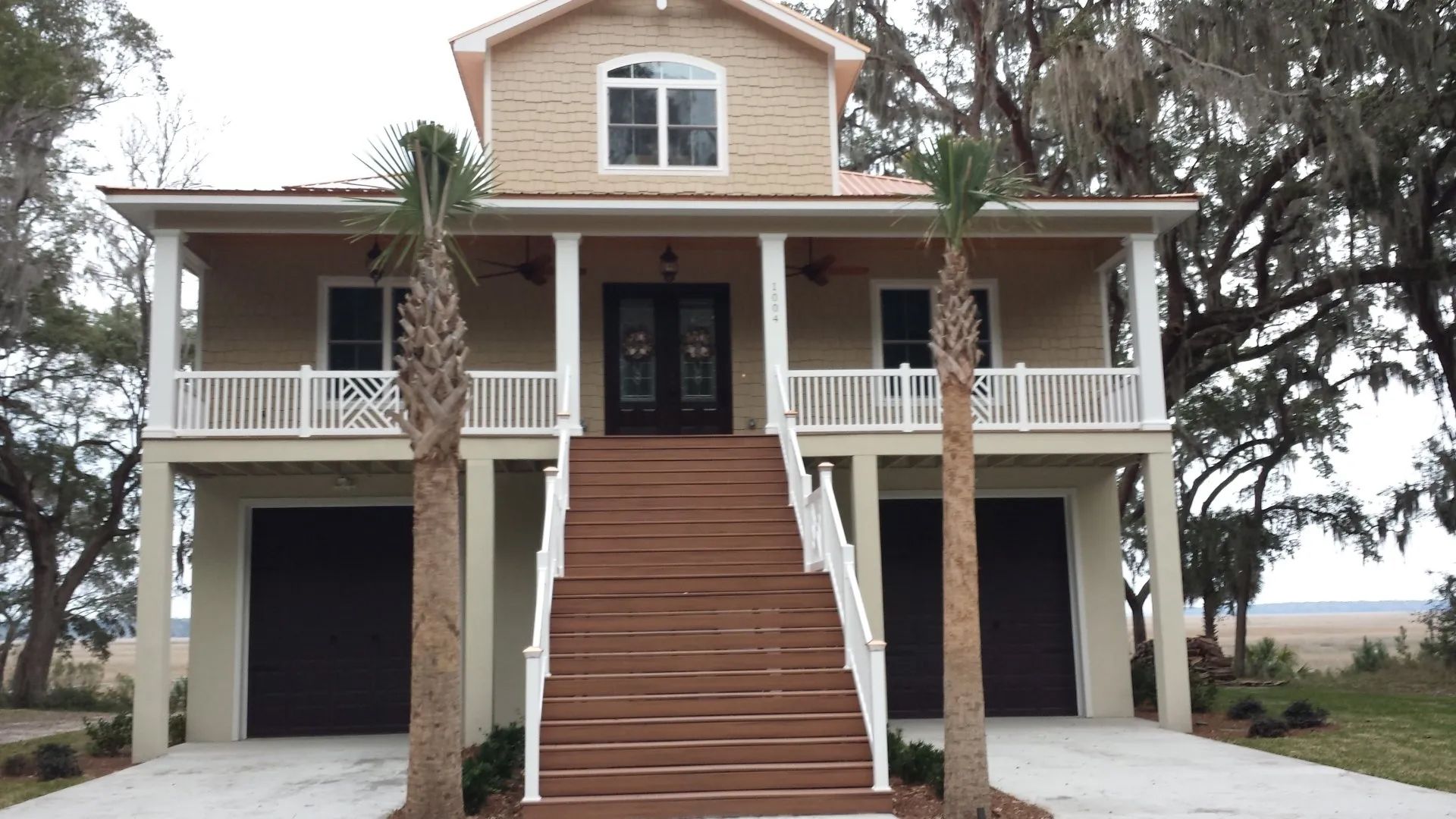a large house with stairs leading up to the front door