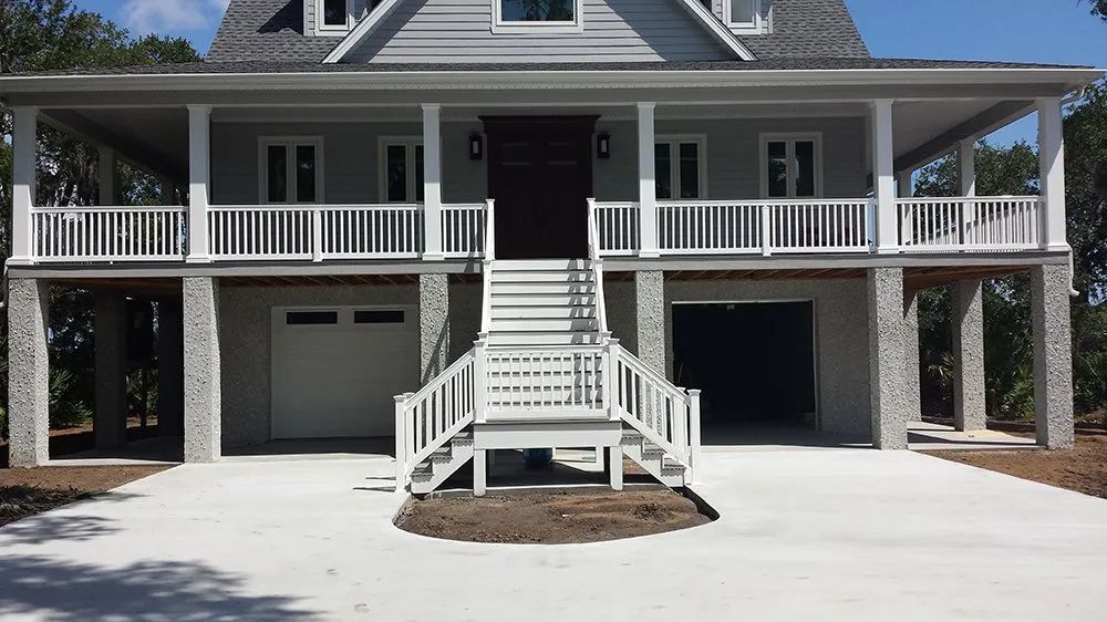 a large house with a concrete driveway in front of it